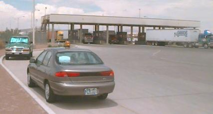 Photo of Inbound 2 data collection point at Primary on the U.S. side, with an official's car in the foreground.