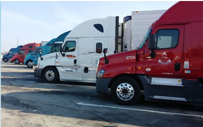 Line of parked tractor trailers.