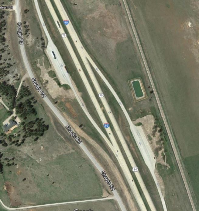 Aerial view of two truck-only parking areas converted from highway rest areas.