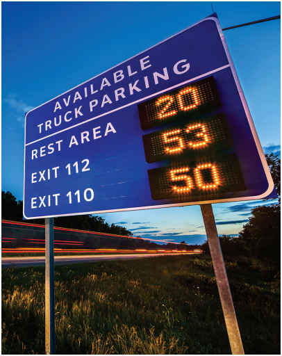 DMS highway sign displaying available parking spaces for three rest areas.