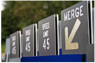 Close up of a series of overhead dynamic speed limit signs.