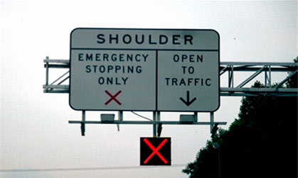 figure 60 - photo - Photograph of I-66 shoulder lane control sign and signal