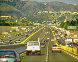 An image showing plastic pylons separate priced lanes from free lanes on State Route 91