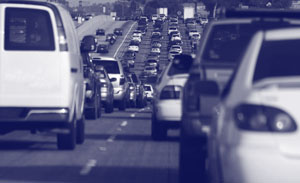 Photograph of an interstate road backed up with automobile traffic.