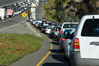 Photo. Traffic backed up on an entrance ramp to a highway, where the traffic volume is also very heavy.