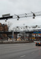 Photo of roadways with toll gantries, representing entrance/exit points in an area with cordon-pricing.