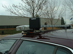 Photo showing the technology associated with the MnPASS I-394 HOT lanes.  The device attached to the vehicle's roof-mounted light bar.