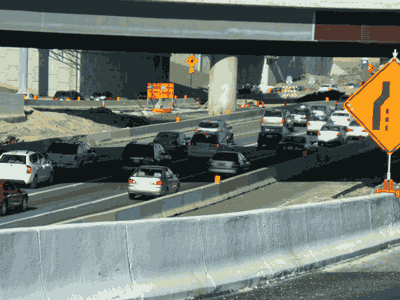 Picture of a traffic on a major highway with a work zone set up.