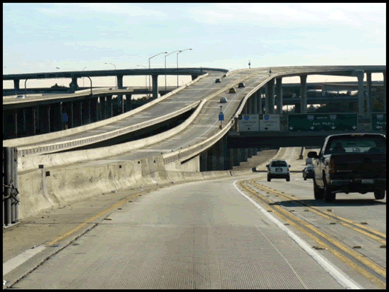 A photograph of a single interstate lane connecting HOV lanes.