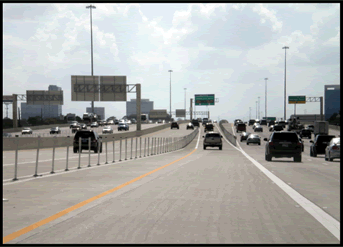 A photograph of an interstate lane with single stripe lane slip ramp leading to the HOT lanes.