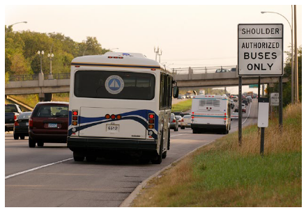 Bus traveling on a bus-only shoulder on an interstate.