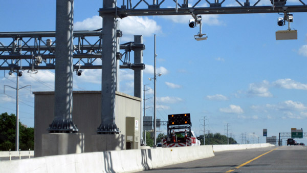 Photo of a jersey barrier-protected enforcement area providing a service vehicle safe refuge from traffic at the side of the road beyond the emergency shoulder.