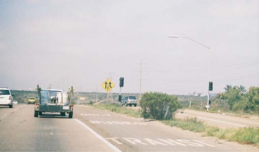 Photo of white pavement markings used in California on the part-time shoulder lanes where BOS operations are used. The pavement reads “Transit Buses Only” with each successive word coming downstream of the previous.