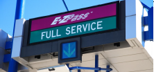 A gantry-mounted sign above a lane advises drivers that it is an E-ZPass full service lane.