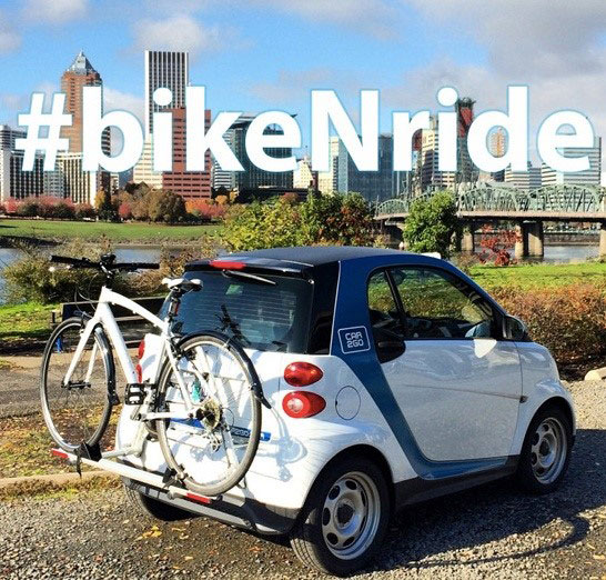 a car2go vehicle with a bicycle rack attached to the vehicle