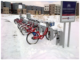 A bike rack filled with red bicycles.