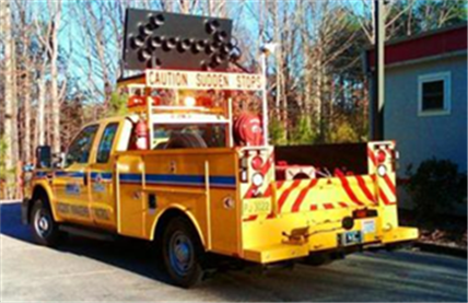 Title: Figure 4. Photo. North Carolina's Incident Management Assistance Patrol Vehicles. - Description: The figure provides a side and rear view of North Carolina's Incident Management Assistance Patrol Vehicle. The photo is courtesy of the North Carolina Department of Transportation. 