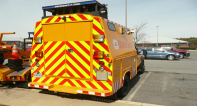 Title: Figure 8. Photo. Example of Rear Conspicuity Striping. - Description: The figure is 3 photos of conspicuity striping on the rear of Maryland service patrol vehicles. The photo is courtesy of the Maryland State Highway Administration. 