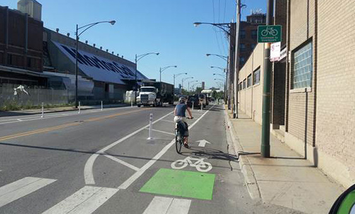 A bicycist riding in a protected bicycle lane