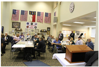 A meeting room filled with people.