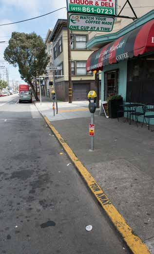 photo of a street curb painted yellow with the words 'Tow Away' in black