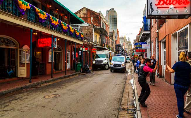 photo of traffic passing a parked delivery truck on a French Quarter street in New Orleans