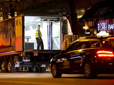 photo of a man in the back of a truck making an off-peak delivery in downtown Sweden