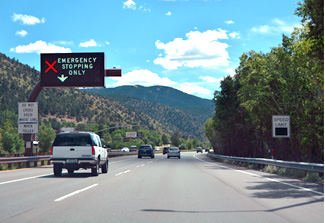 Photo shows closed dynamic part-time shoulder, indicated by a sign with a red x and emergency stopping only message.