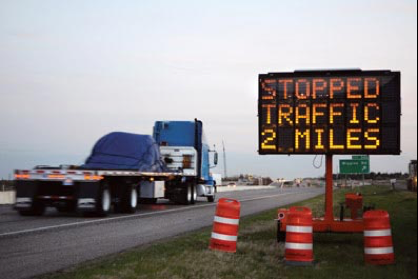 Roadside changeable message sign showing traffic status message.