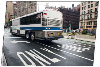 A bus approaching an intersection in an urban area