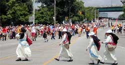 photo showing a crowd of event patrons traversing a closed, multi-lane roadway