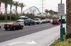 photo showing a sign, located adjacent to a right-turn lane on multi-lane intersection approach, stating "right lane must turn right – bus exempt"