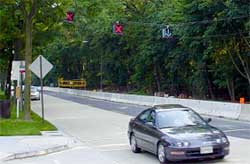 photo showing three lane control signals hanging on a temporary span wire over a three-lane construction zone