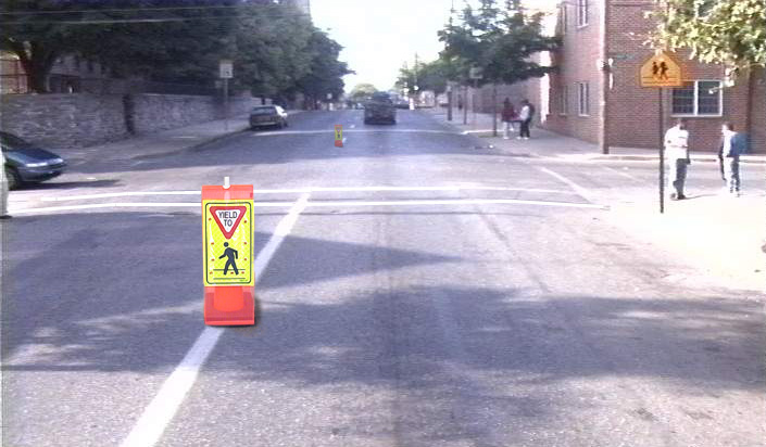 photo of pedestrian crossing sign on center line in roadway