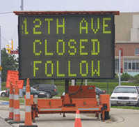 Photograph of dynamic message sign advising travelers of detour ahead