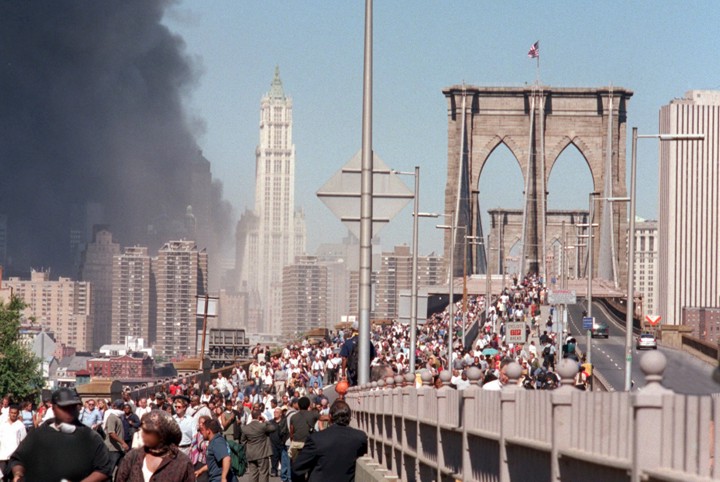 Photograph of pedestrians evacuating a large city.