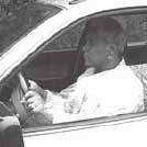 Photograph - Woman (motorist) driving an automobile.