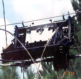 photograph of a splice box attached to cables, showing cables in front of the box