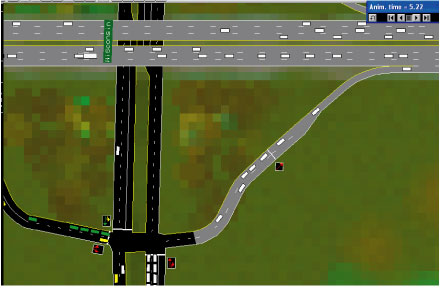 Figure 12.  Ramp meter geometry.  Screen capture.  This is a screen capture of a simulation animation that represents traffic flow at a highway overpass and four lanes of traffic traveling under the overpass.  The figure illustrates the coding of a ramp meters on a eastbound freeway on-ramp.  