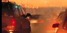 Cars on a road at dusk.