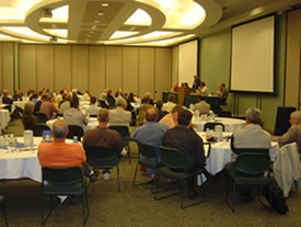 Participants listen to a question and answer session at the Maintenance Decision Support System Showcase in Omaha, Nebraska.