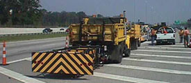 work vehicles on highway shoulder