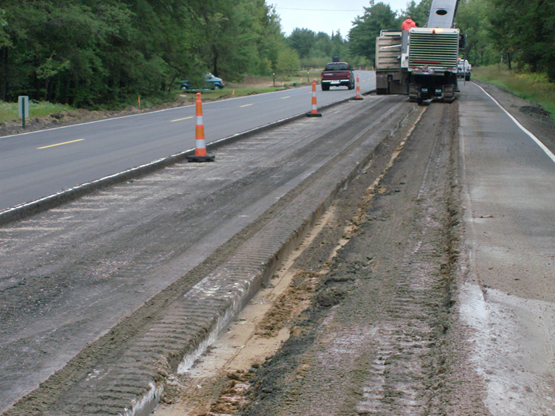 Asphalt being taken up from one lane of a two-lane roadway.