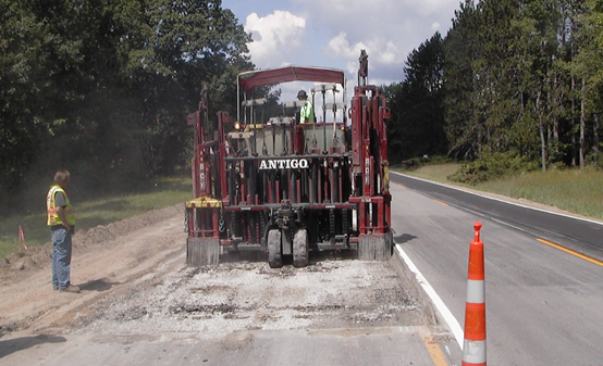 Construction equipment rubblizing existing pavement