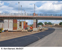 Repaving operations below the overpass. Photo credit: R. Kent Barnard, MnDOT.