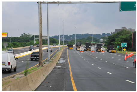 A complete road closure with each of the closed lanes containing a 'road closed' barrier and a truck with an attenuator mounted on the rear.