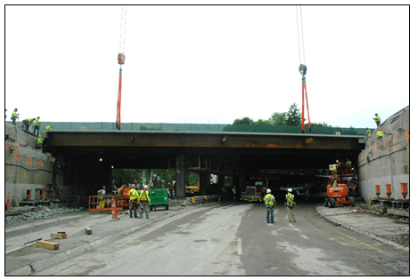 A crane lowering a precast modular unit into place.