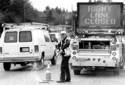 workman and right lane closed sign