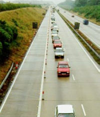 Overhead photo of one lane of traffic between an empty work zone lane and an empty traffic lane.