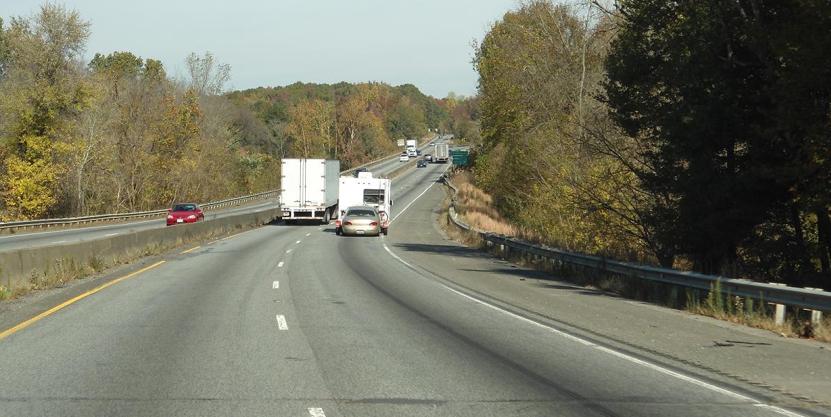 A photo shows the approach to the I-85 Bridge prior to construction.